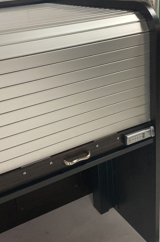 Keyless digital lock installed at the front of a rolltop desk, portrait view