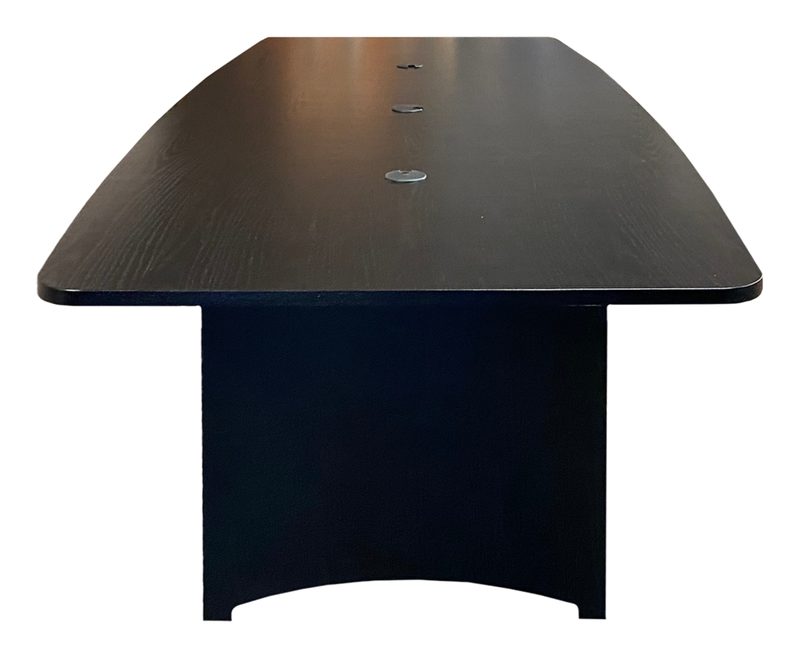 Podcasting desk, side view of the curved worksurface and equipment bay in a studio setting